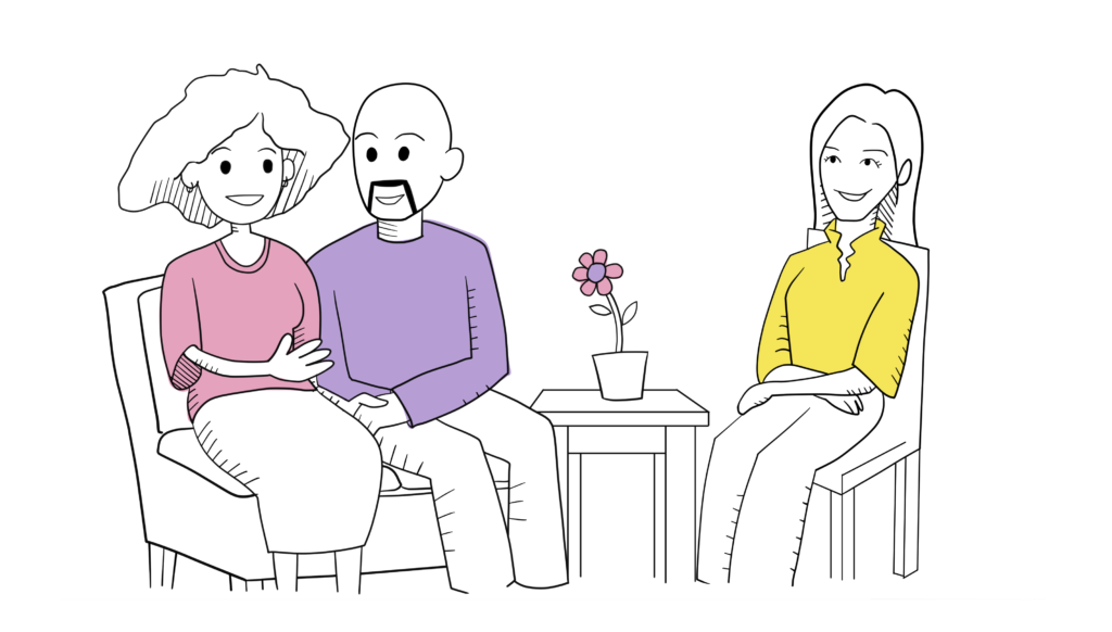 A man and woman couple sit across from a therapist. The man holds the woman's hand supportively.
