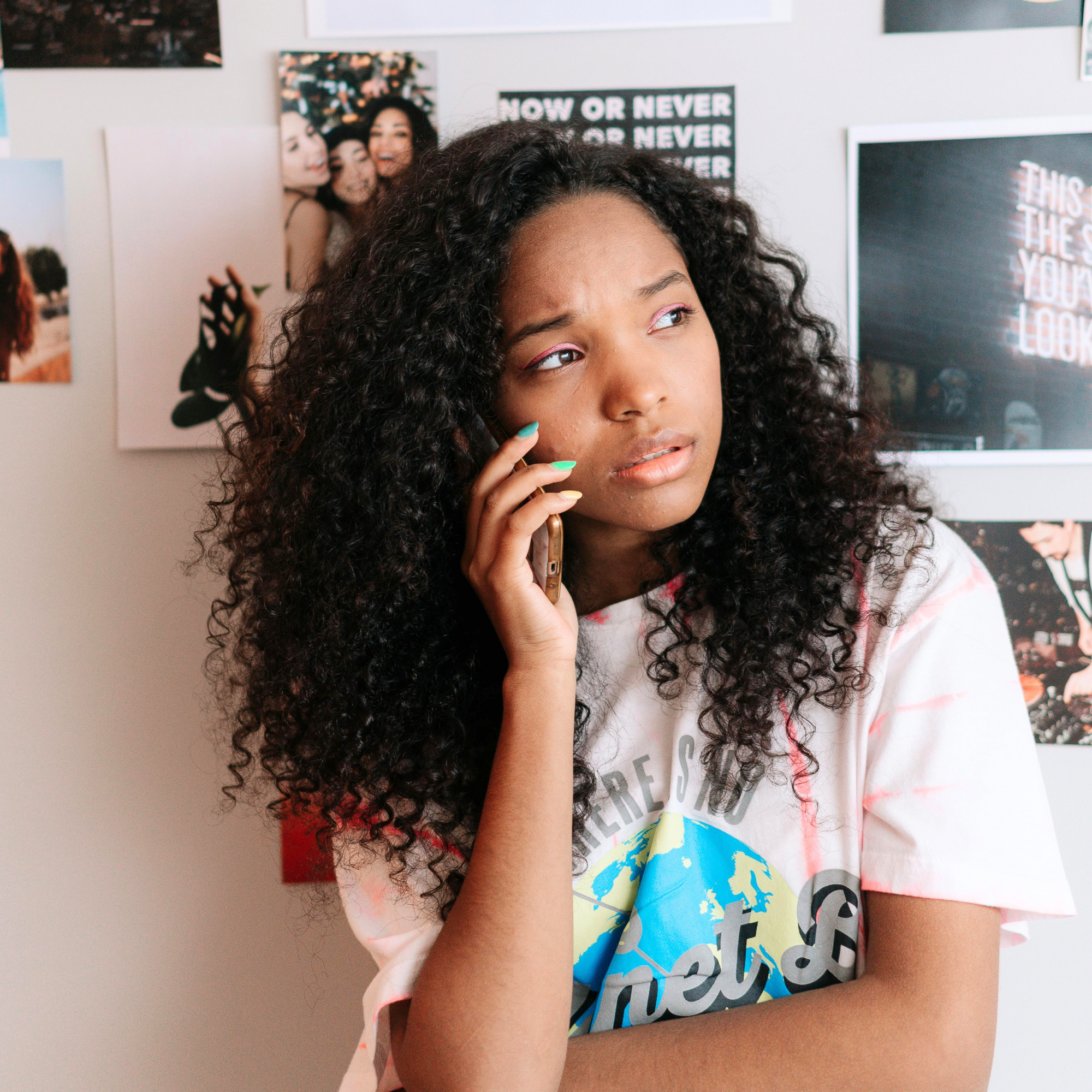 teen on phone looks distressed