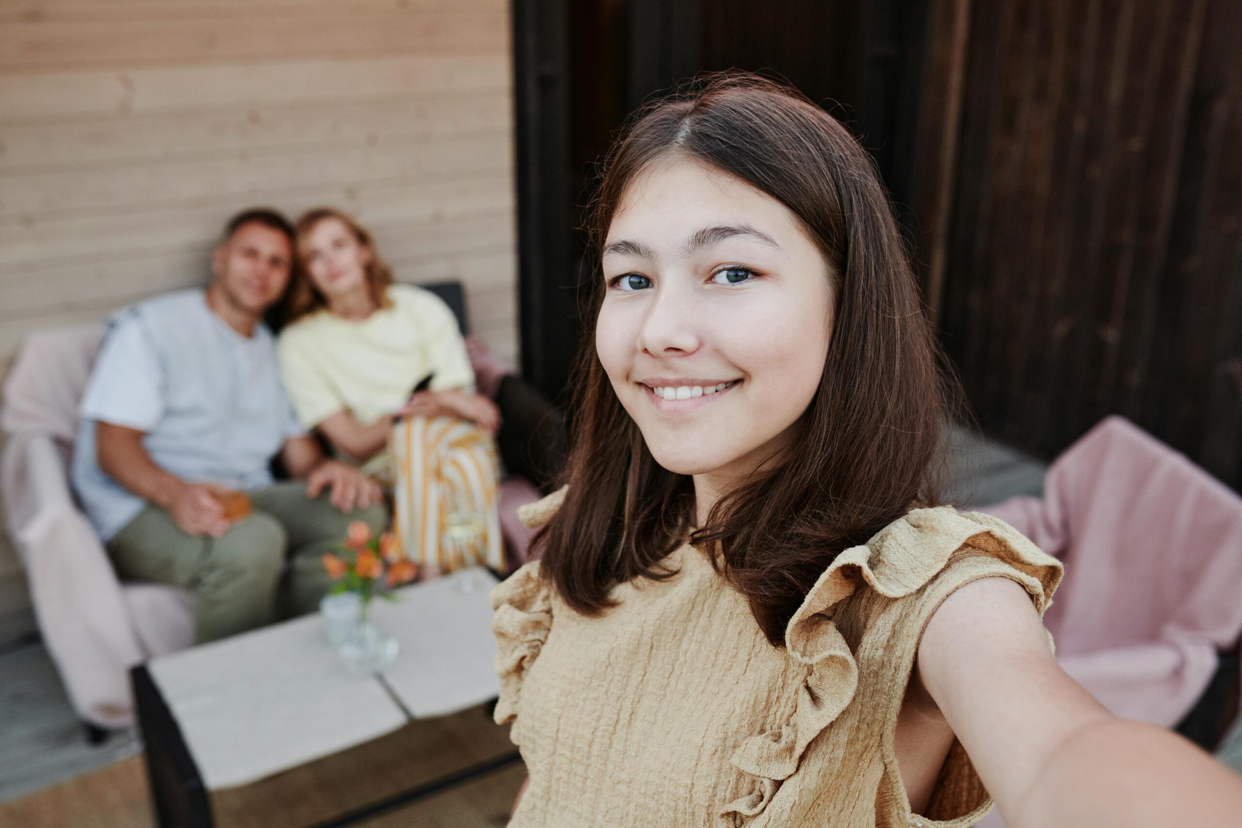 teen daughter takes selfie with parents